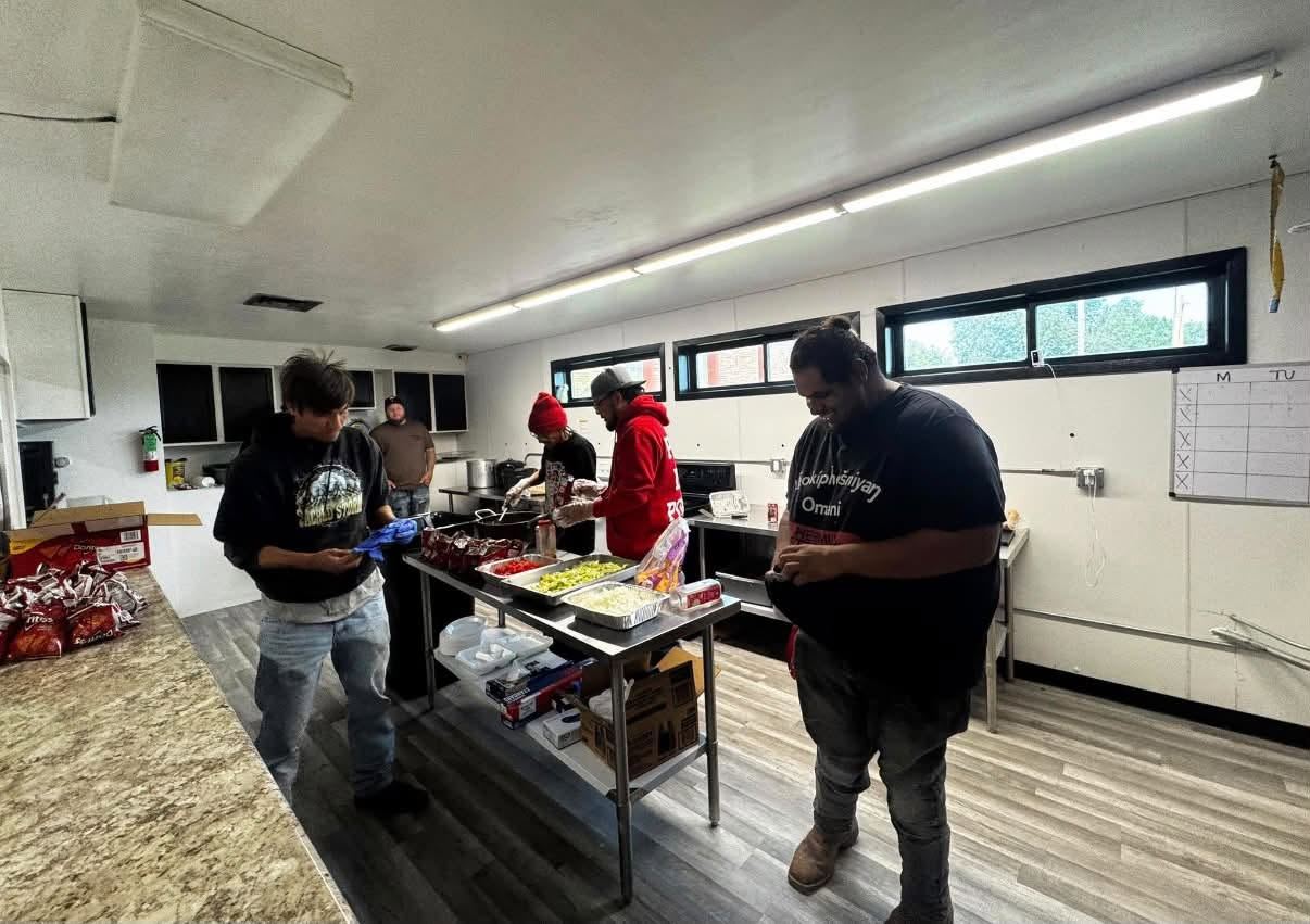 Workforce team members preparing food together as part of hands-on training and community food work